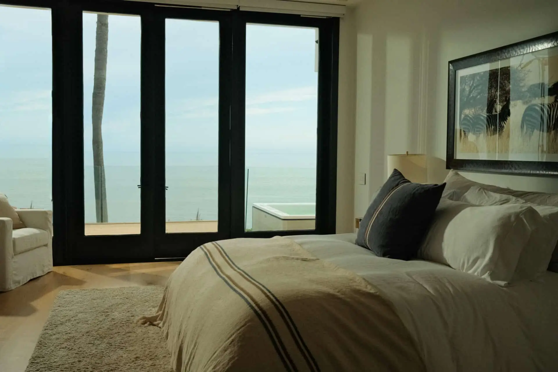 A made-up suite in the Malibu house, glass doors looking onto the deck and the ocean